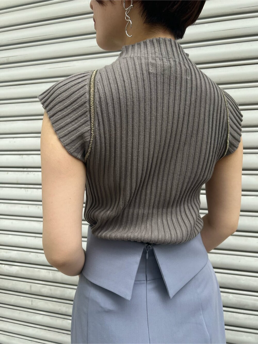 ベージュ系のハンドバッグ、その他のパンプス、ブルー系のスカートを着用したレディースの夏コーディネートの7枚目の写真