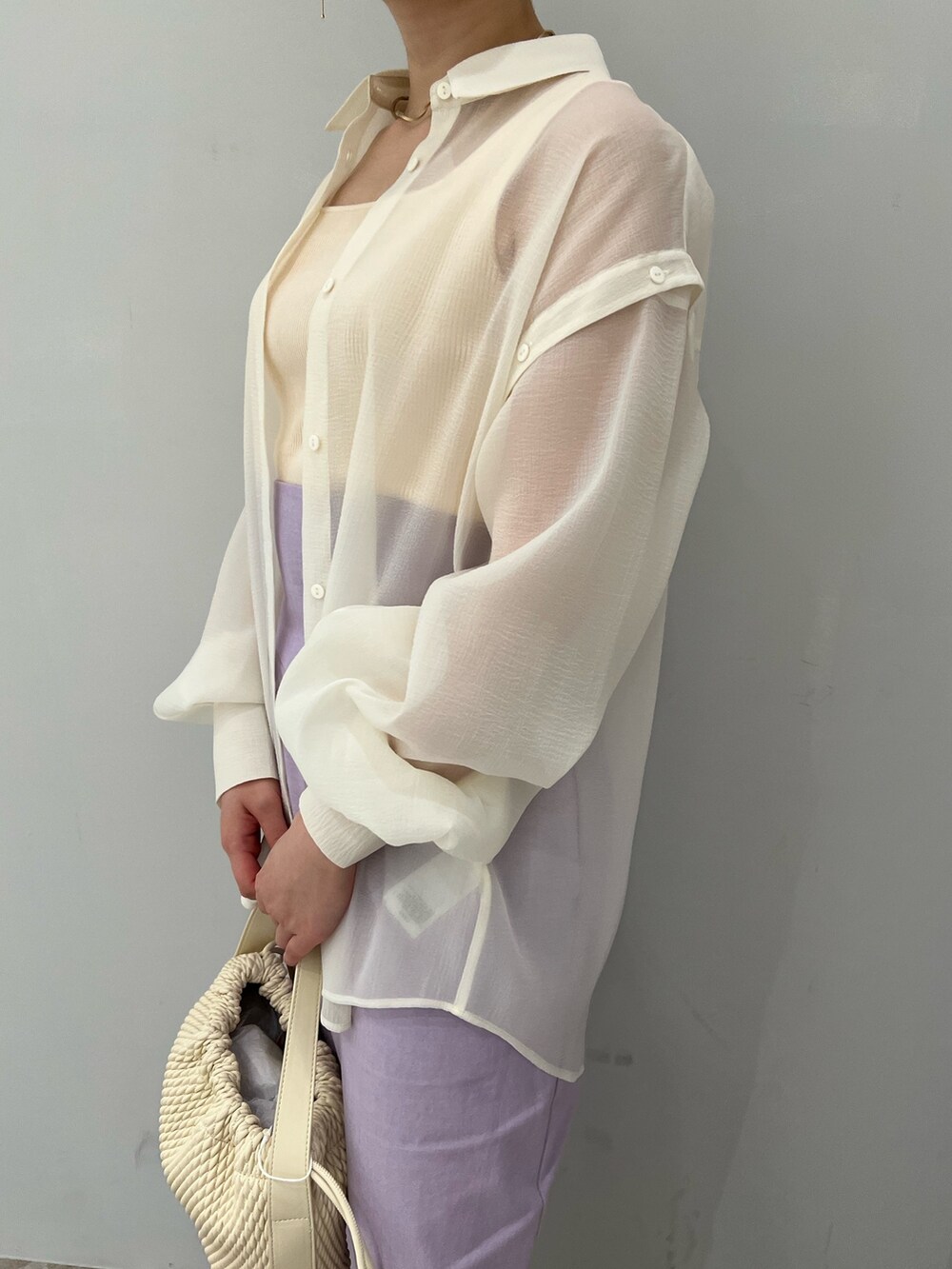 ホワイト系のニット/セーター、ホワイト系のシャツ/ブラウス、ベージュ系のサンダルを着用したレディースの春コーディネートの3枚目の写真