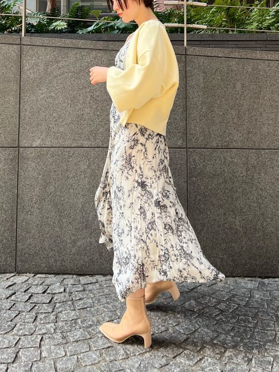 ベージュ系のブーツ、ホワイト系のハンドバッグ、イエロー系のカーディガン/ボレロを着用したレディースの春コーディネートの2枚目の写真