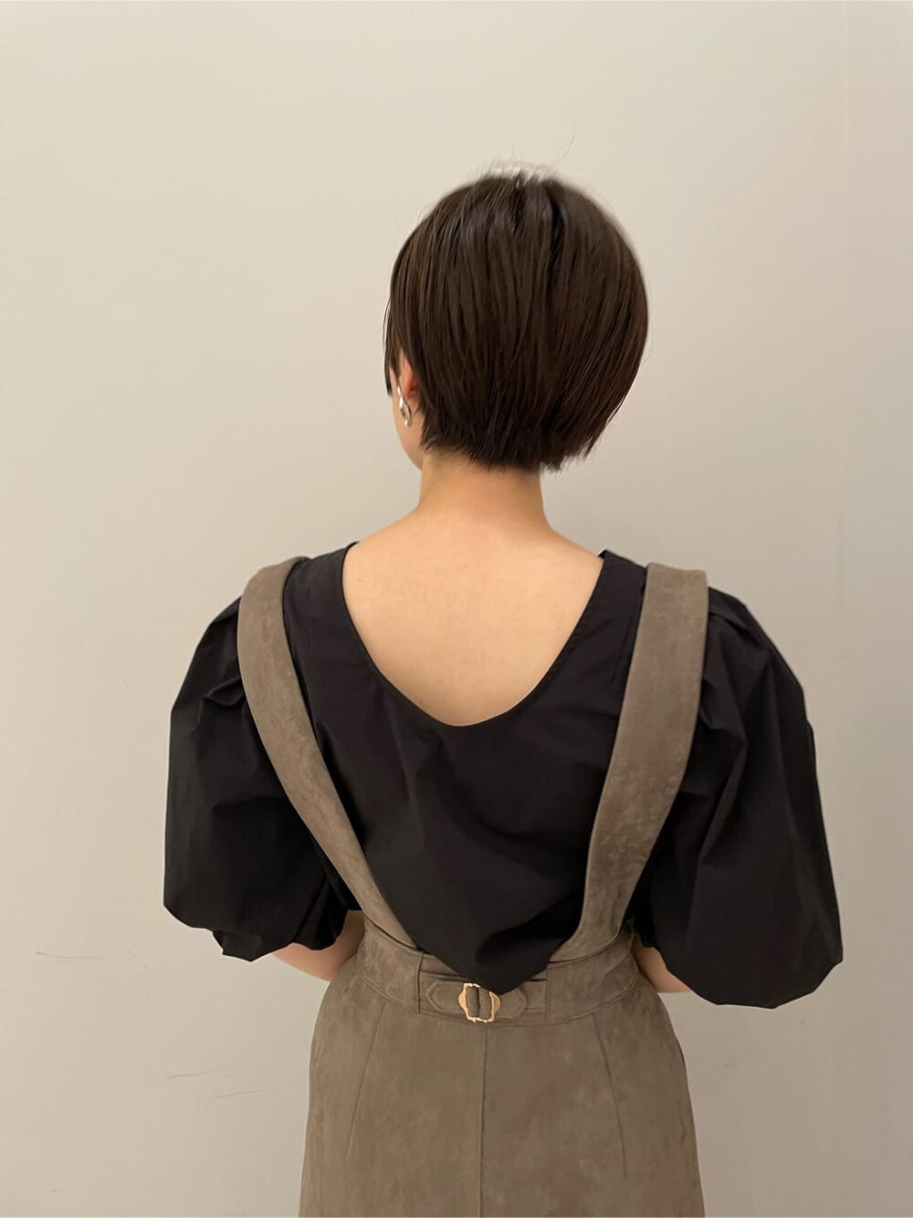 ブラック系のシャツ/ブラウス、グレー系のスカート、ベージュ系のブーツを着用したレディースの秋コーディネートの6枚目の写真