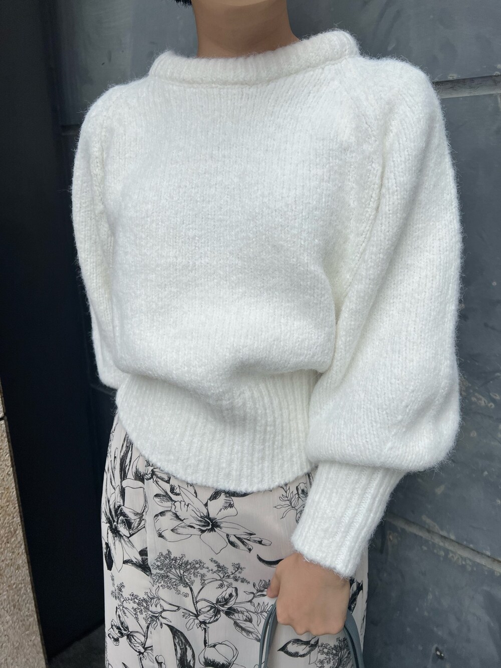 ベージュ系のブーツ、ブルー系のショルダーバッグ、ホワイト系のスカートを着用したレディースの冬コーディネートの6枚目の写真