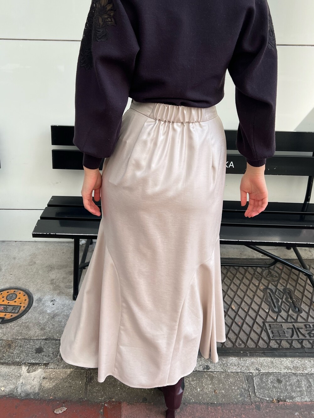 レッド系のブーツ、グレー系のスカート、グレー系のニット/セーターを着用したレディースの秋コーディネートの9枚目の写真