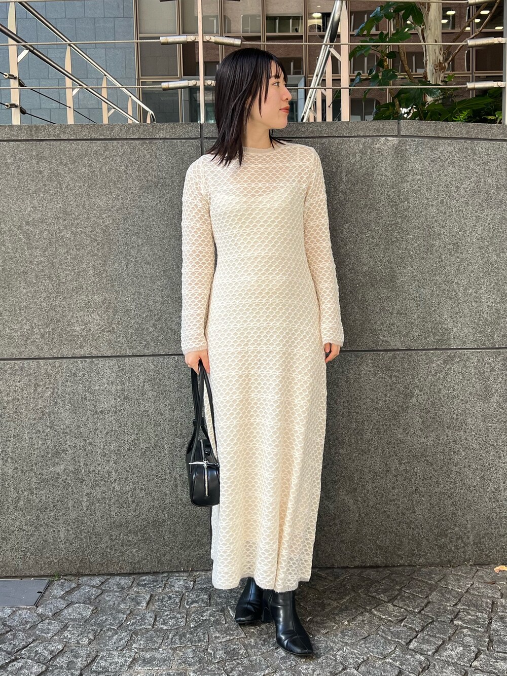 ホワイト系のブルゾン、ホワイト系のワンピース、ブラック系のブーツを着用したレディースの秋コーディネートの5枚目の写真