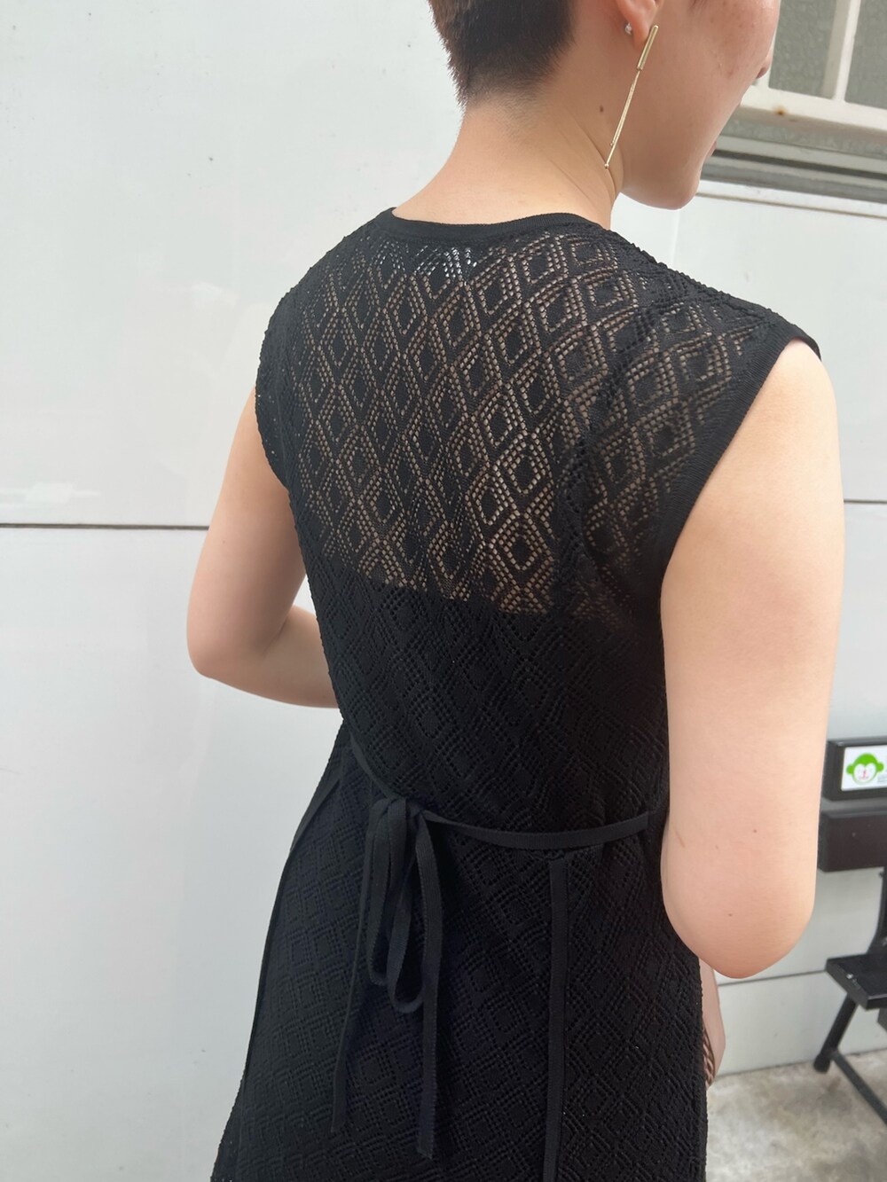 ベージュ系のサンダル、ホワイト系のハンドバッグ、ブラック系のワンピースを着用したレディースの夏コーディネートの6枚目の写真