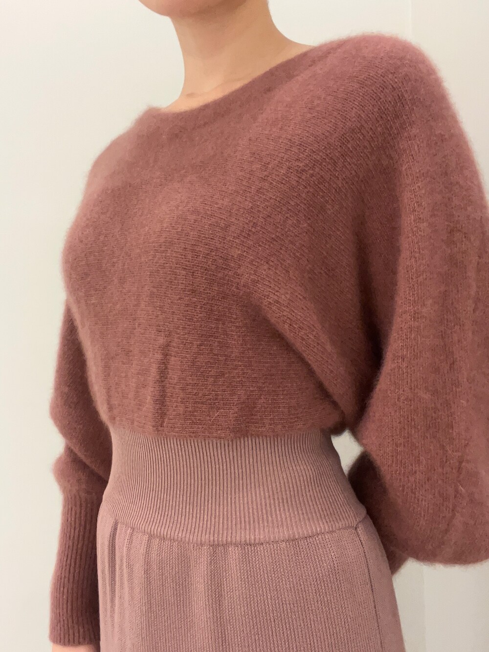 ピンク系のカーディガン/ボレロ、ピンク系のワンピース、ベージュ系のブーツを着用したレディースの秋コーディネートの7枚目の写真