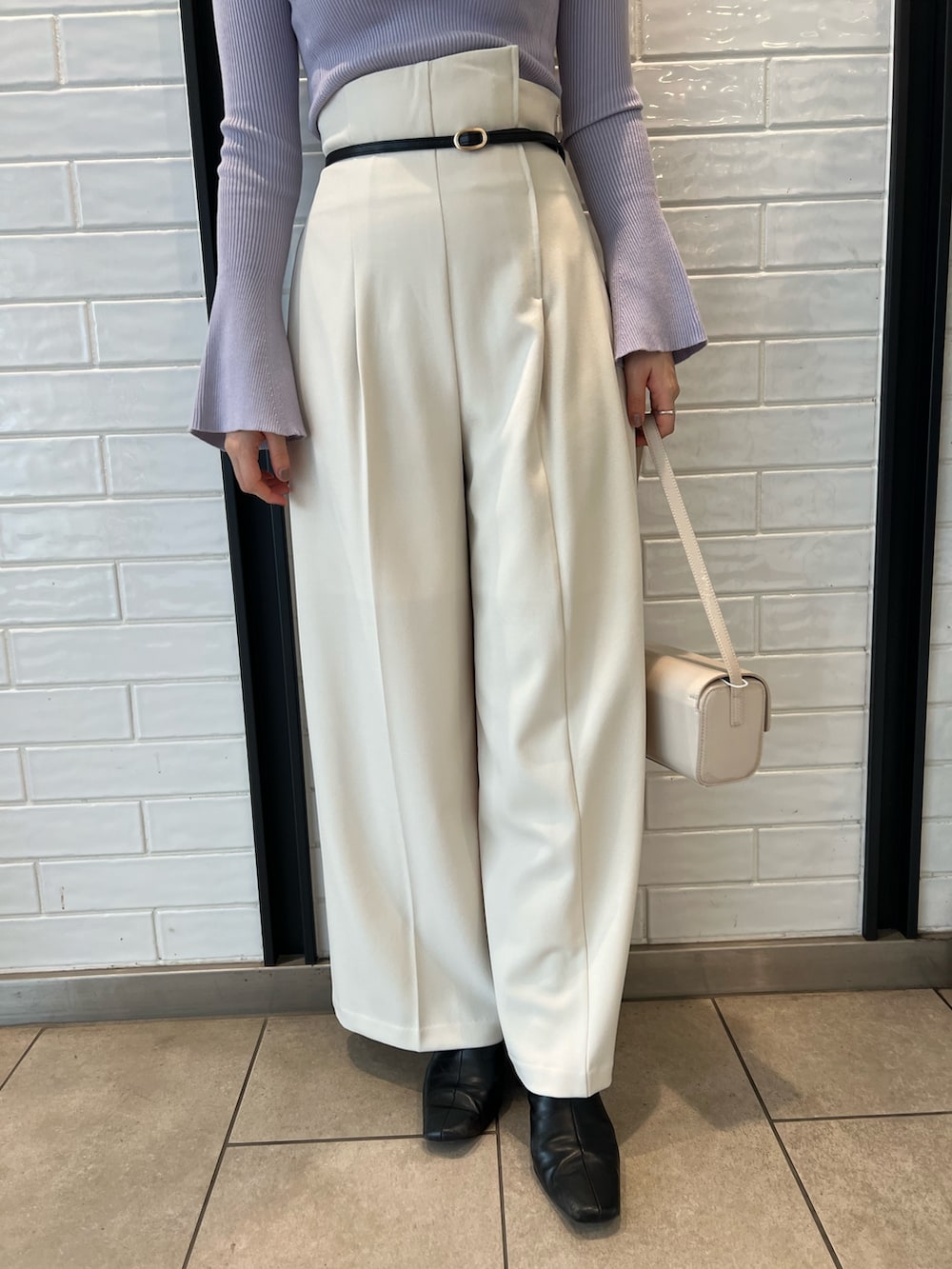 パープル系のニット/セーター、ホワイト系のその他パンツを着用したレディースの冬コーディネートの5枚目の写真