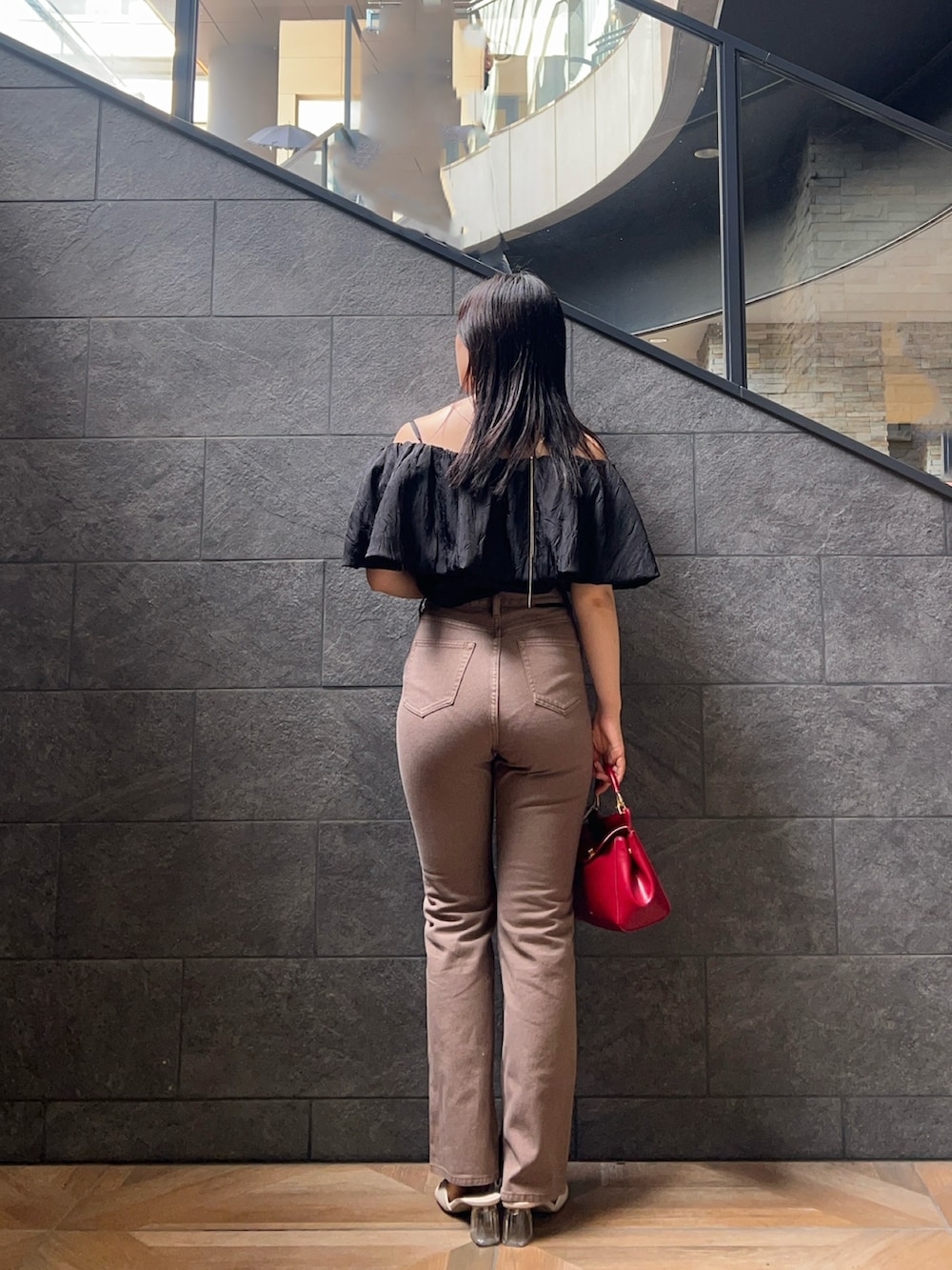 ベージュ系のデニムパンツ、ブラック系のシャツ/ブラウス、ホワイト系のサンダルを着用したレディースの夏コーディネートの3枚目の写真