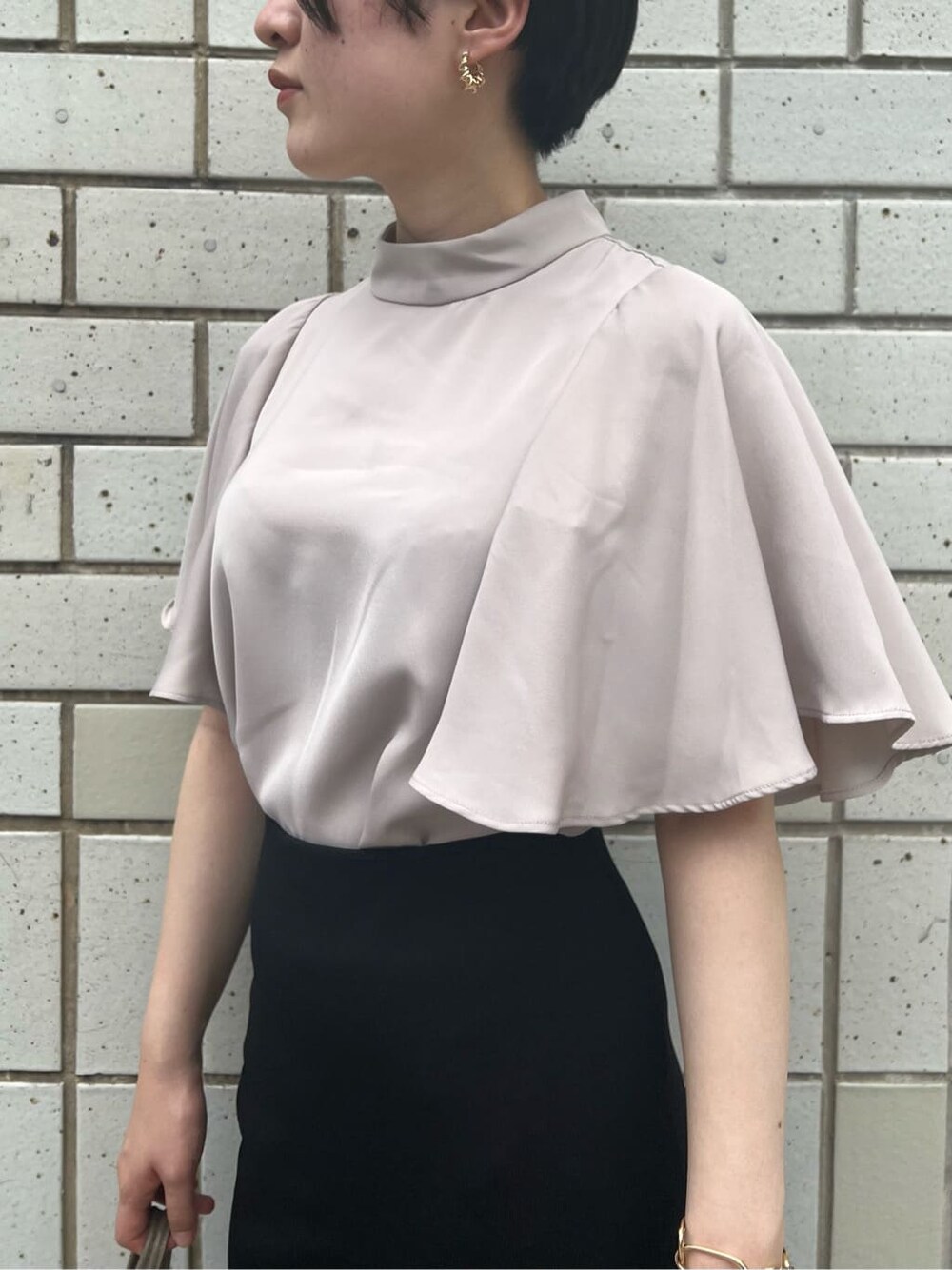 ベージュ系のハンドバッグ、グリーン系のサンダル、ブラック系のスカートを着用したレディースの夏コーディネートの8枚目の写真