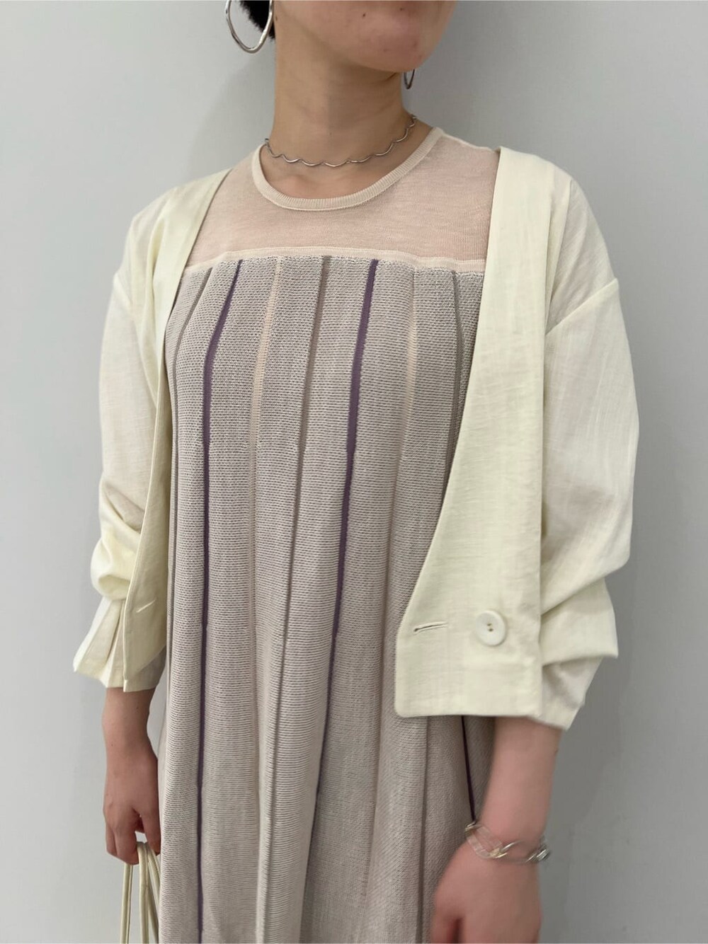 ホワイト系のノーカラージャケット、その他のパンプス、パープル系のワンピースを着用したレディースの夏コーディネートの4枚目の写真