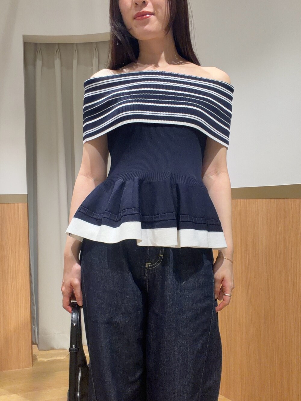ブルー系のデニムパンツ、ブルー系のニット/セーター、ブラウン系のサンダルを着用したレディースの夏コーディネートの4枚目の写真