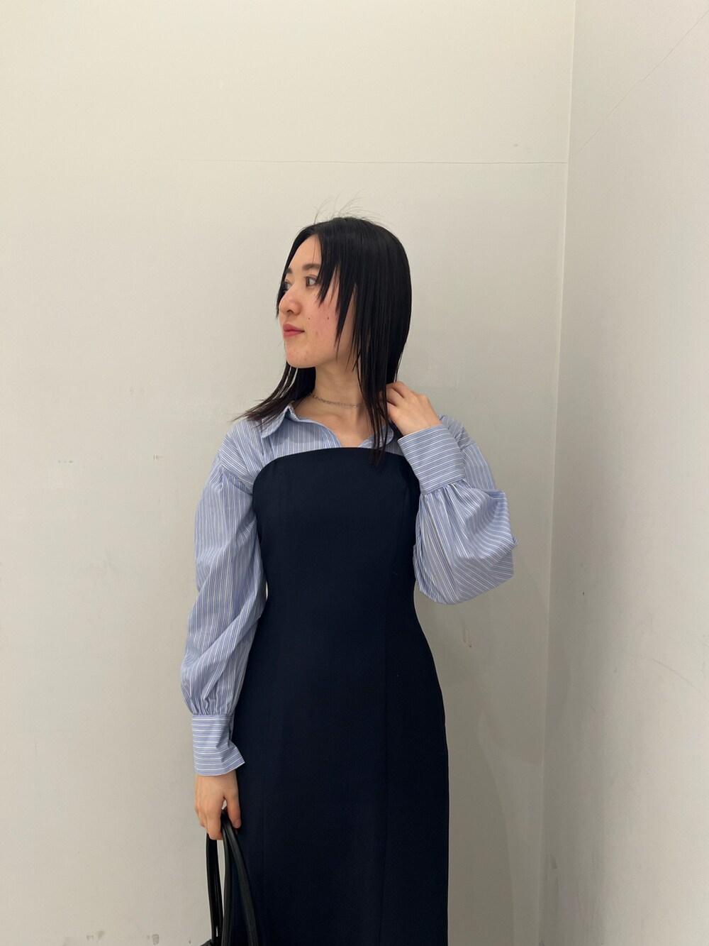 ブルー系のワンピース、グレー系のスニーカーを着用したレディースの冬コーディネートの3枚目の写真