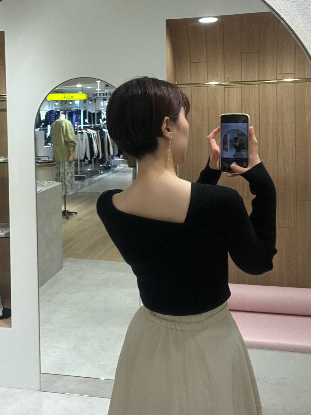 ホワイト系のスカート、ブラック系のニット/セーター、ベージュ系のブーツを着用したレディースの秋コーディネートの6枚目の写真