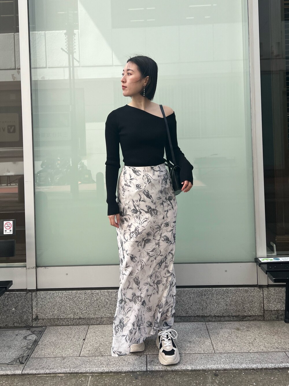 ブラック系のスニーカー、ブラック系のニット/セーター、パープル系のテーラードジャケットを着用したレディースの春コーディネートの4枚目の写真