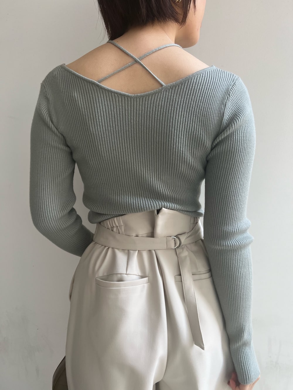 ベージュ系のブーツ、ホワイト系のスラックス、ホワイト系のニット/セーターを着用したレディースの冬コーディネートの7枚目の写真