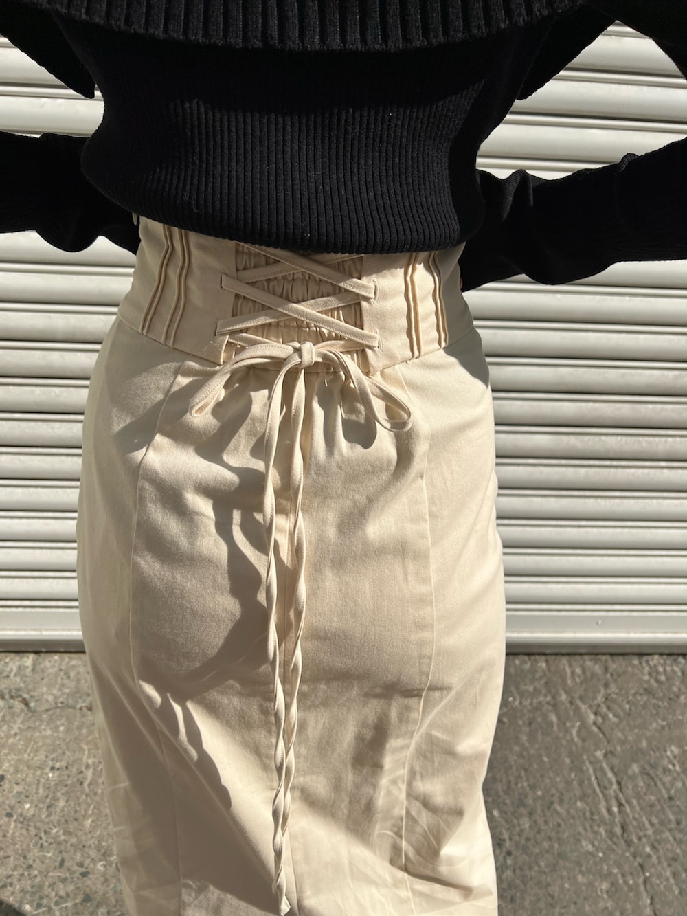 レッド系のブーツ、ホワイト系のスカート、ホワイト系のカーディガン/ボレロを着用したレディースの冬コーディネートの10枚目の写真