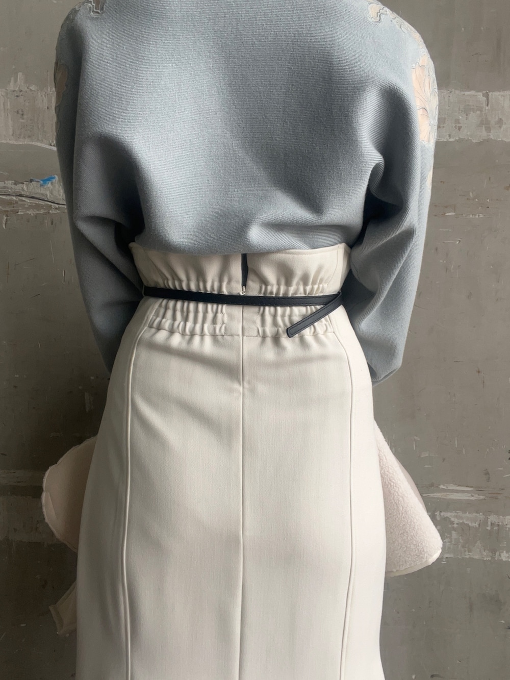 ベージュ系のブーツ、ホワイト系のハンドバッグ、ホワイト系のムートンコートを着用したレディースの秋コーディネートの9枚目の写真