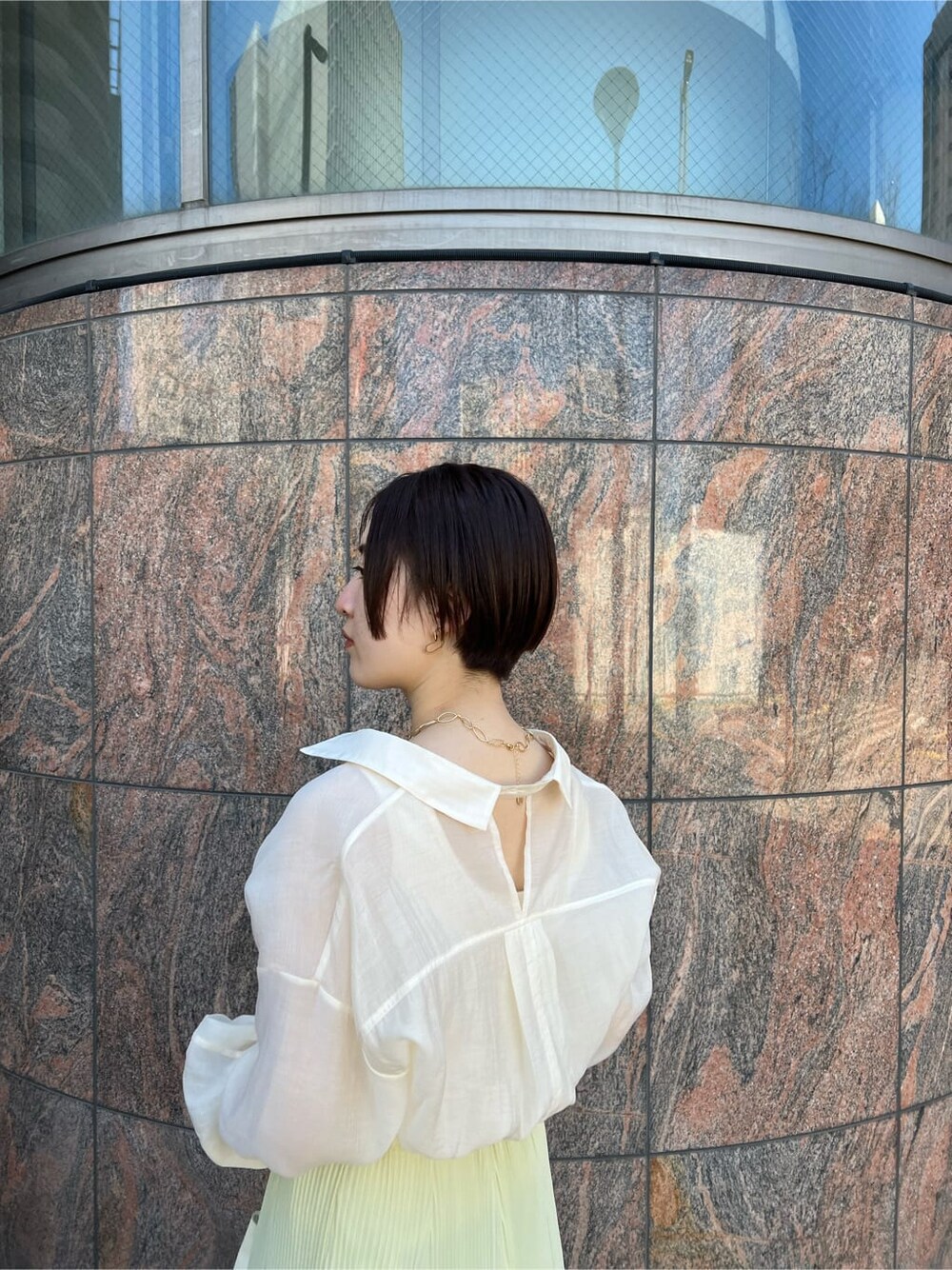 ホワイト系のシャツ/ブラウス、イエロー系のスカート、ホワイト系のハンドバッグを着用したレディースの春コーディネートの7枚目の写真