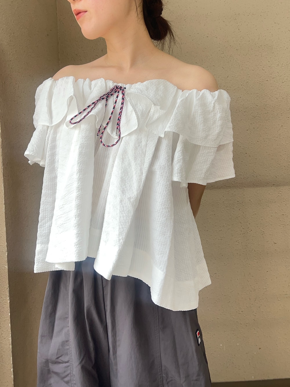 ホワイト系のシャツ/ブラウス、グレー系のその他パンツ、ブラック系のパンプスを着用したレディースの春コーディネートの5枚目の写真