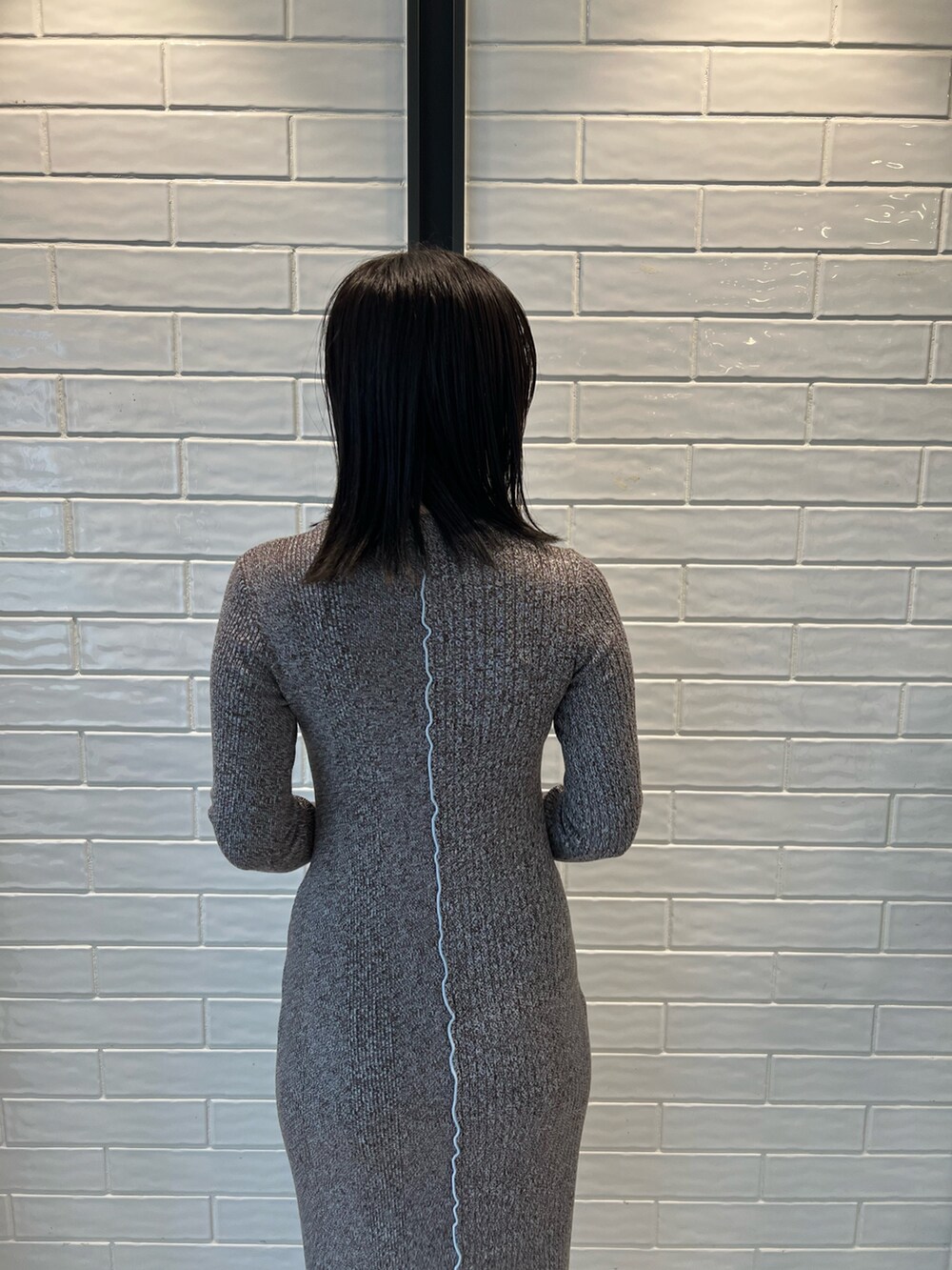 ブラック系のブーツ、ブラック系のショルダーバッグ、ブラック系のワンピースを着用したレディースの秋コーディネートの6枚目の写真