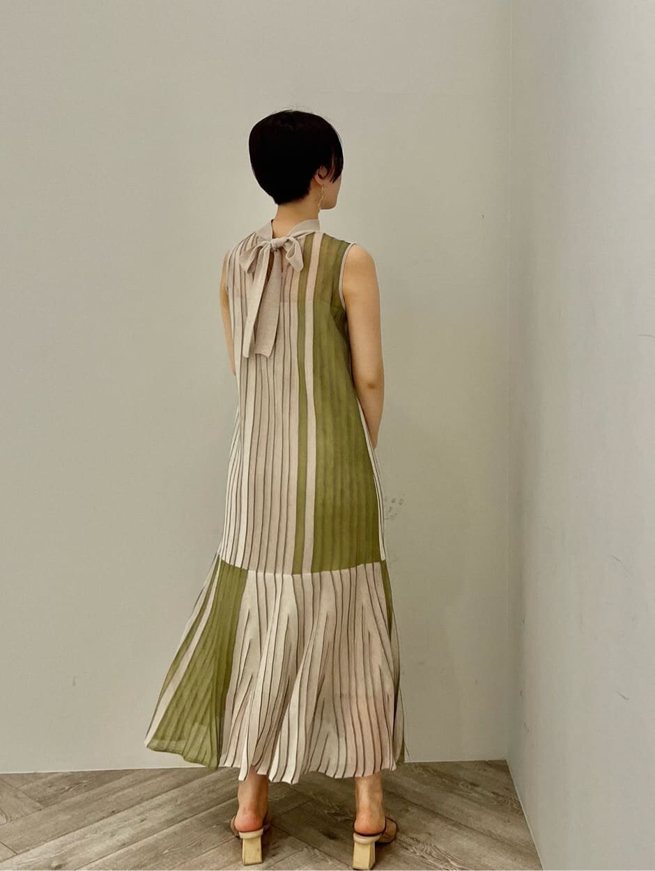 グリーン系のワンピース、グリーン系のサンダル、ゴールド系のピアス（両耳用）を着用したレディースの夏コーディネートの3枚目の写真