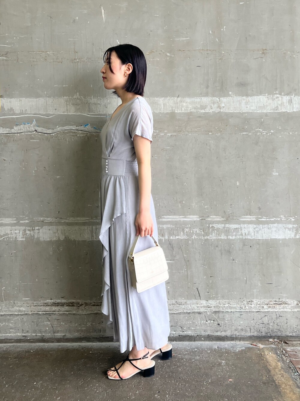 ブラック系のサンダル、ホワイト系のショルダーバッグ、ベージュ系のテーラードジャケットを着用したレディースの春コーディネートの7枚目の写真