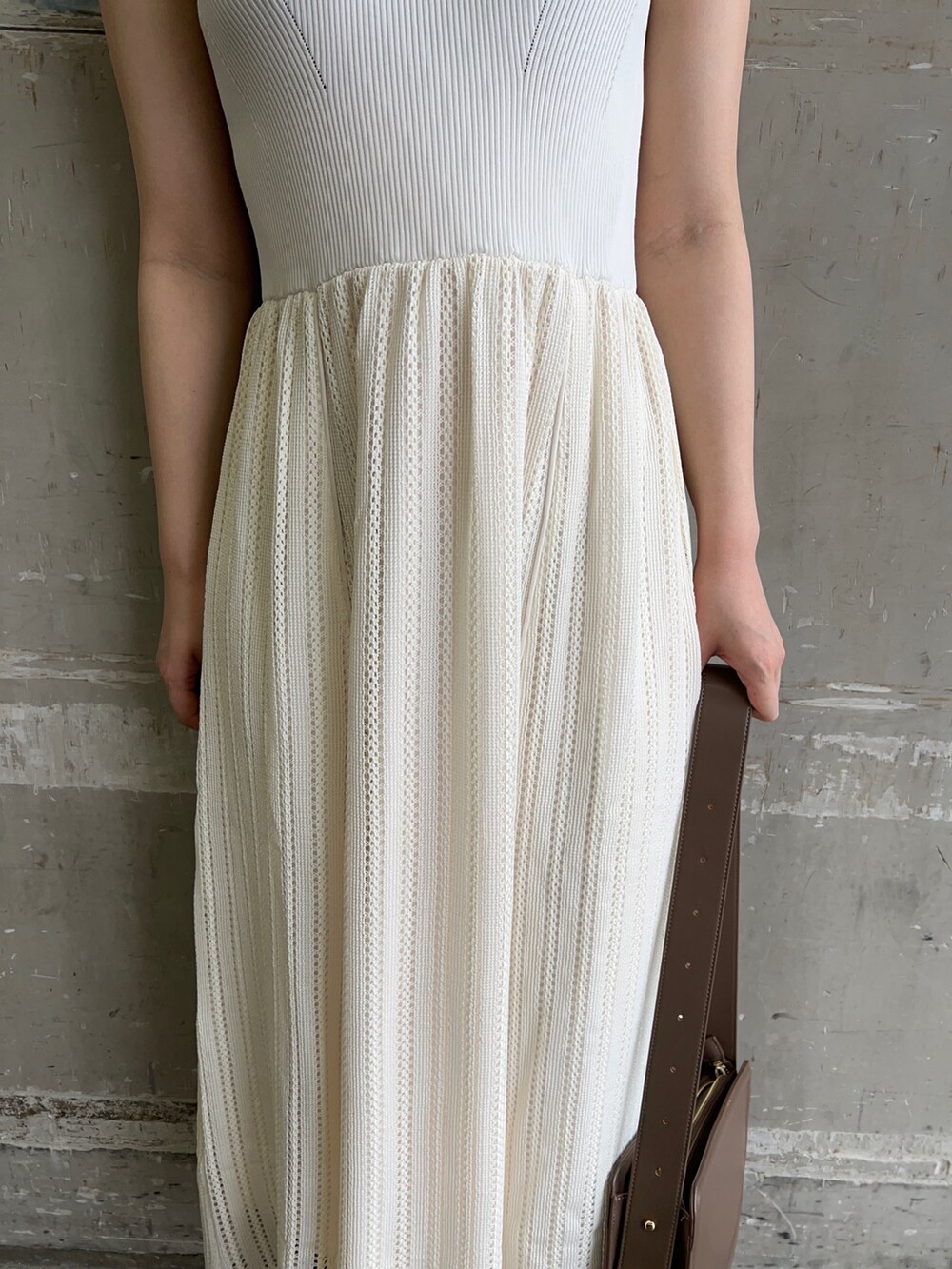 ベージュ系のサンダル、ベージュ系のショルダーバッグ、ホワイト系のワンピースを着用したレディースの夏コーディネートの5枚目の写真