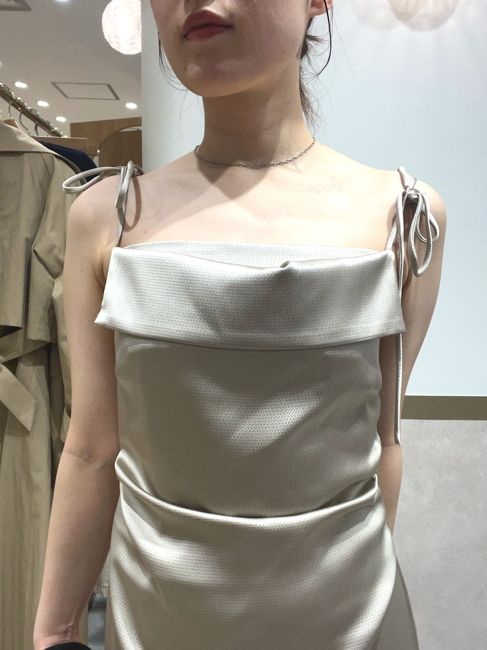 ベージュ系のワンピース、ブラウン系のテーラードジャケット、グリーン系のパンプスを着用したレディースの春コーディネートの5枚目の写真