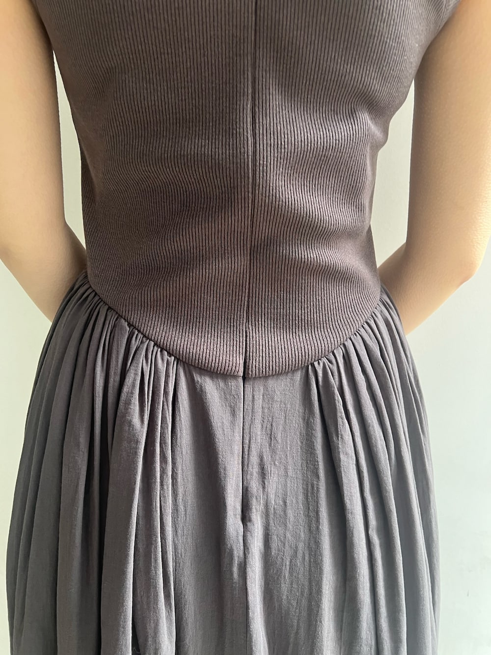 ブラック系のハンドバッグ、グレー系のワンピース、ホワイト系のテーラードジャケットを着用したレディースの春コーディネートの10枚目の写真