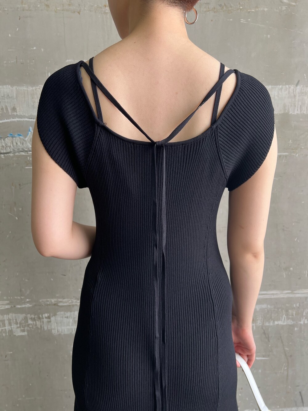 ブラック系のワンピース、ホワイト系のハンドバッグ、ベージュ系のサンダルを着用したレディースの夏コーディネートの8枚目の写真