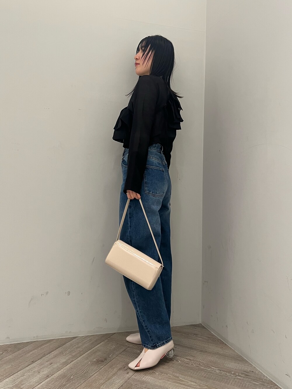 ブルー系のデニムパンツ、ブラック系のシャツ/ブラウスを着用したレディースの冬コーディネートの2枚目の写真