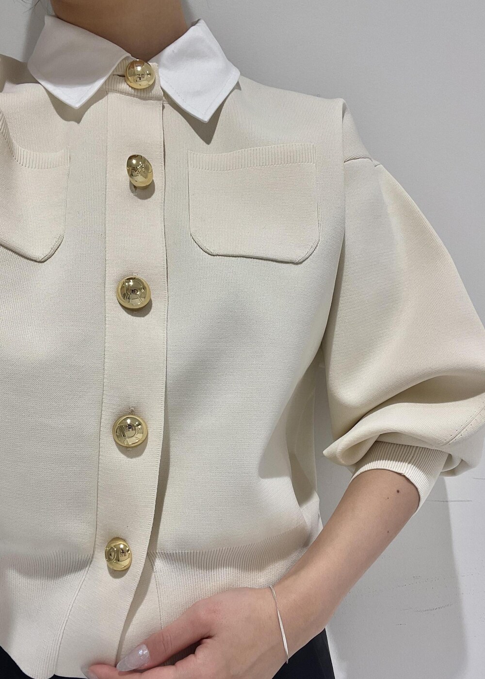 ブラック系のブーツ、ブラック系のスラックス、ブラック系のショルダーバッグを着用したレディースの冬コーディネートの5枚目の写真