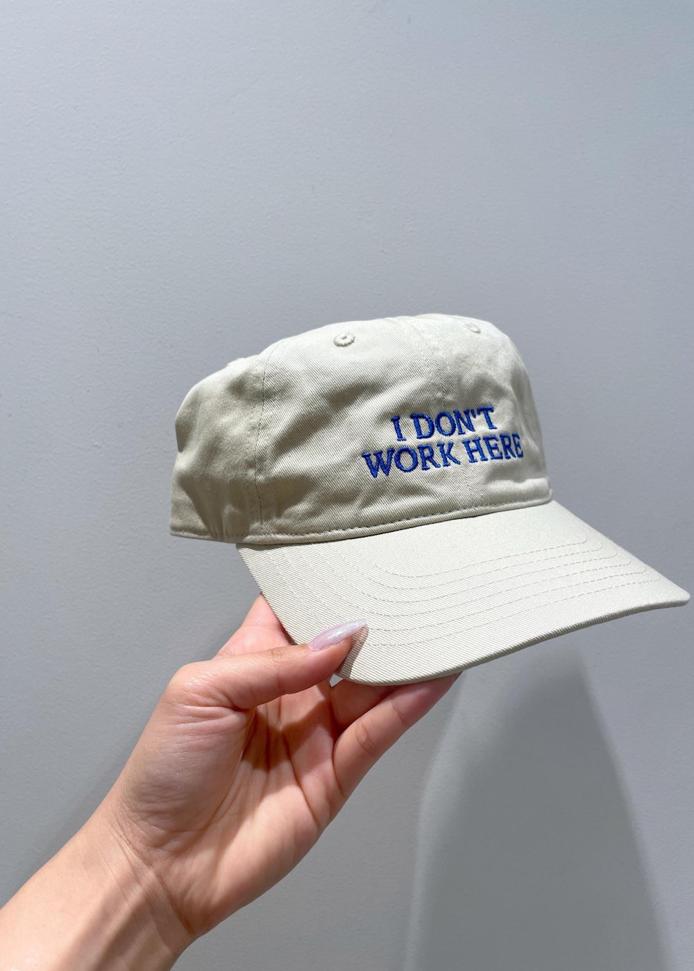 ブラウン系のハンドバッグ、ベージュ系のワンピース、ホワイト系のネックレスを着用したレディースの夏コーディネートの6枚目の写真