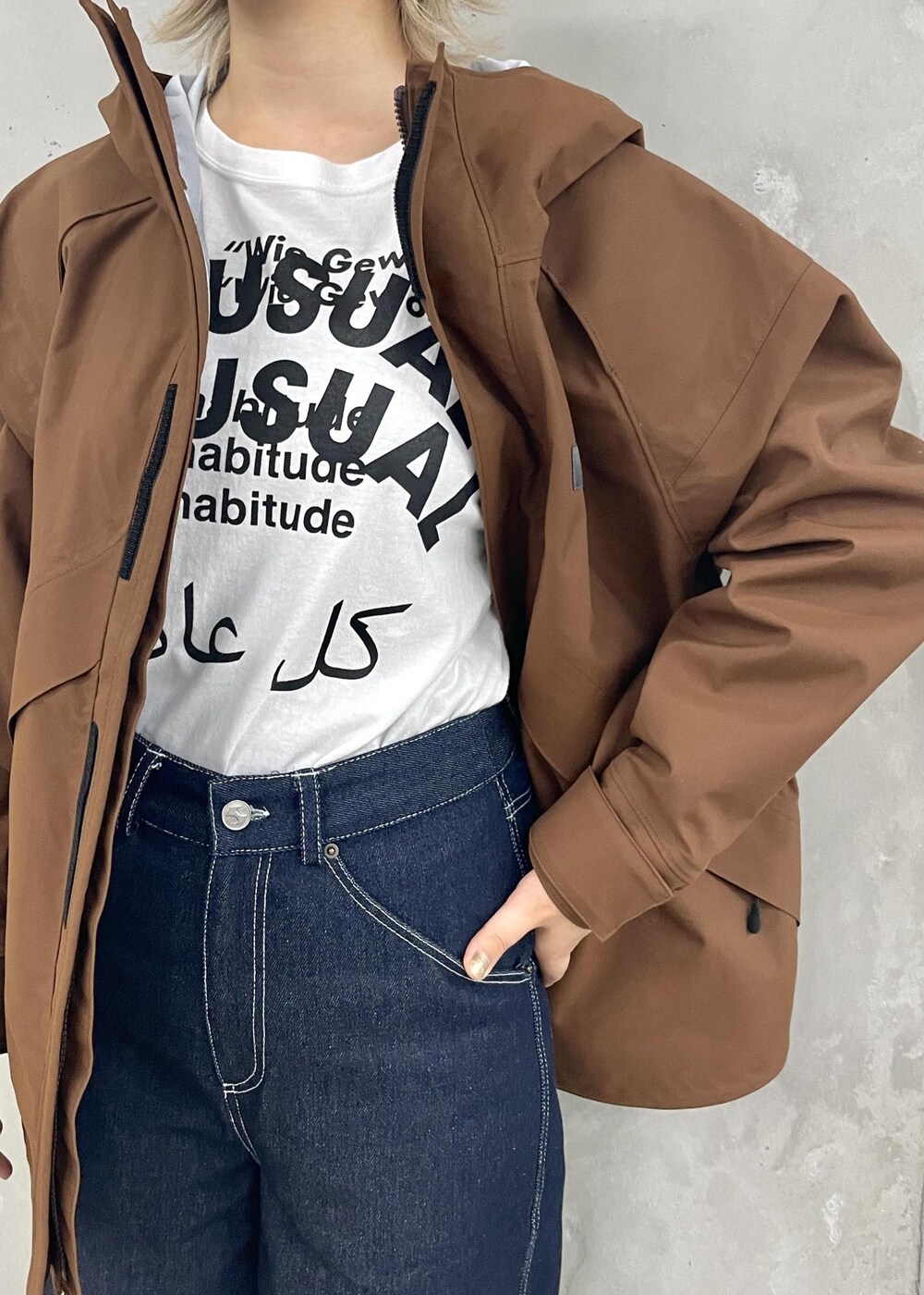 ホワイト系のTシャツ/カットソー、ブラウン系のマウンテンパーカー、ホワイト系のブーツを着用したレディースの夏コーディネートの5枚目の写真