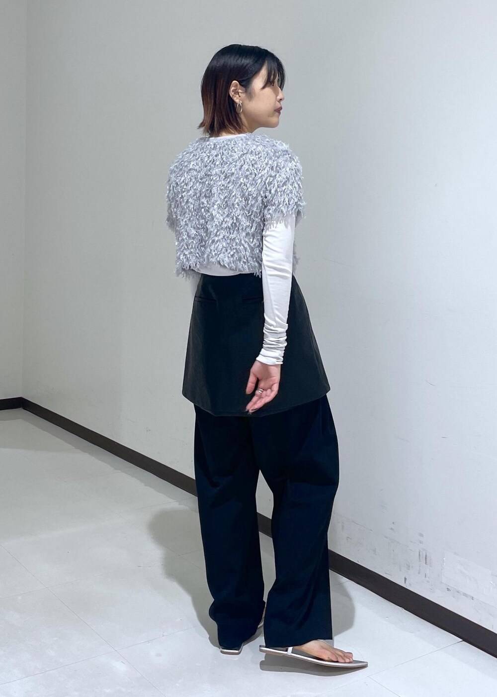 シルバー系のサンダル、グレー系のTシャツ/カットソー、ブラック系のスカートを着用したレディースの夏コーディネートの5枚目の写真