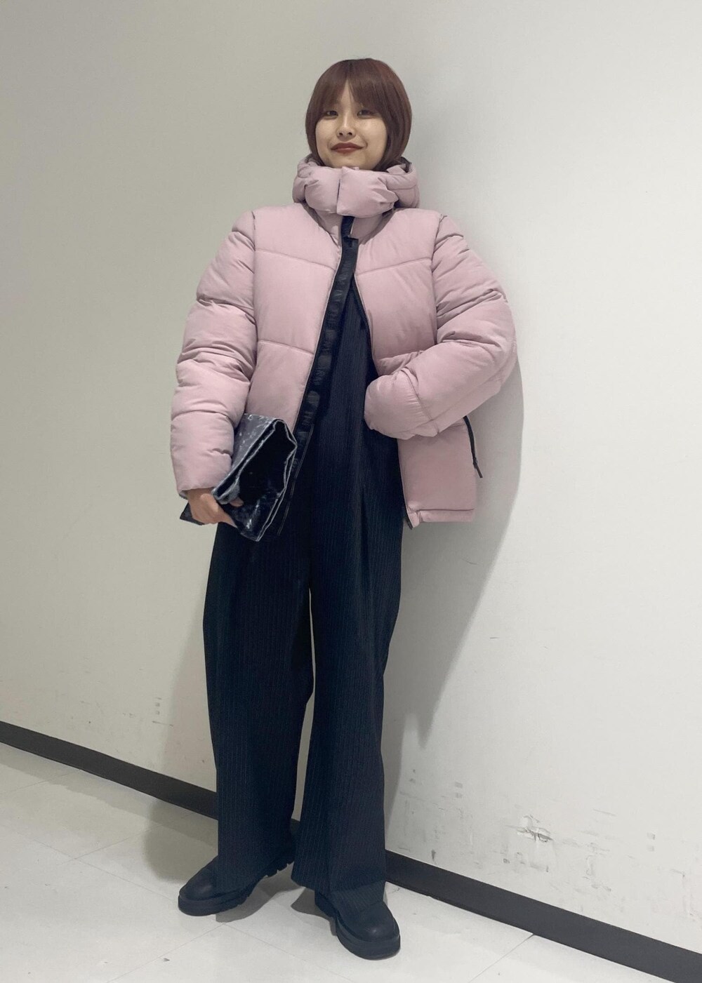 ブラック系のブーツ、ピンク系のダウンジャケット/コート、ブラック系のTシャツ/カットソーを着用したレディースの秋コーディネートの5枚目の写真