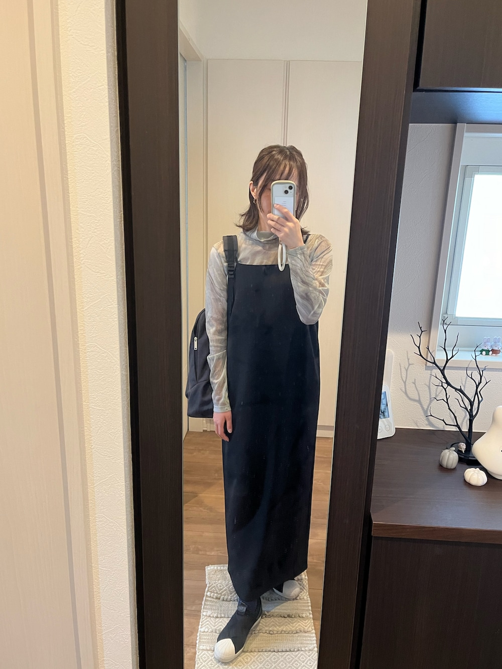 ブルー系のTシャツ/カットソー、ブラック系のワンピース、ブラック系のバックパック/リュックを着用したレディースの秋コーディネートの2枚目の写真