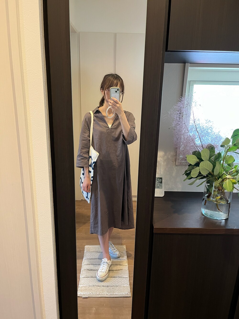 ブラウン系のワンピース/ドレス、グリーン系のトートバッグ、ホワイト系のスニーカーを着用したレディースの夏コーディネートの3枚目の写真