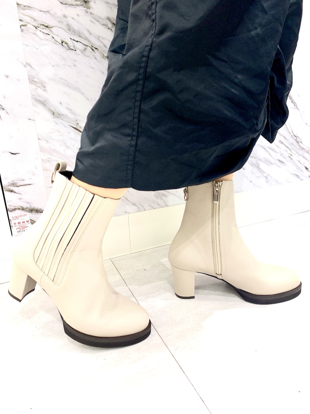 ホワイト系のブーツを着用したレディースの秋コーディネートの2枚目の写真