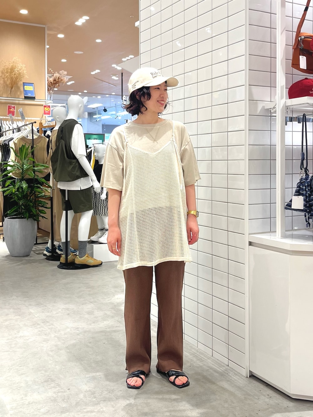ブラック系のサンダル、ホワイト系のキャミソール、ブラウン系のその他パンツを着用したレディースの春コーディネートの4枚目の写真