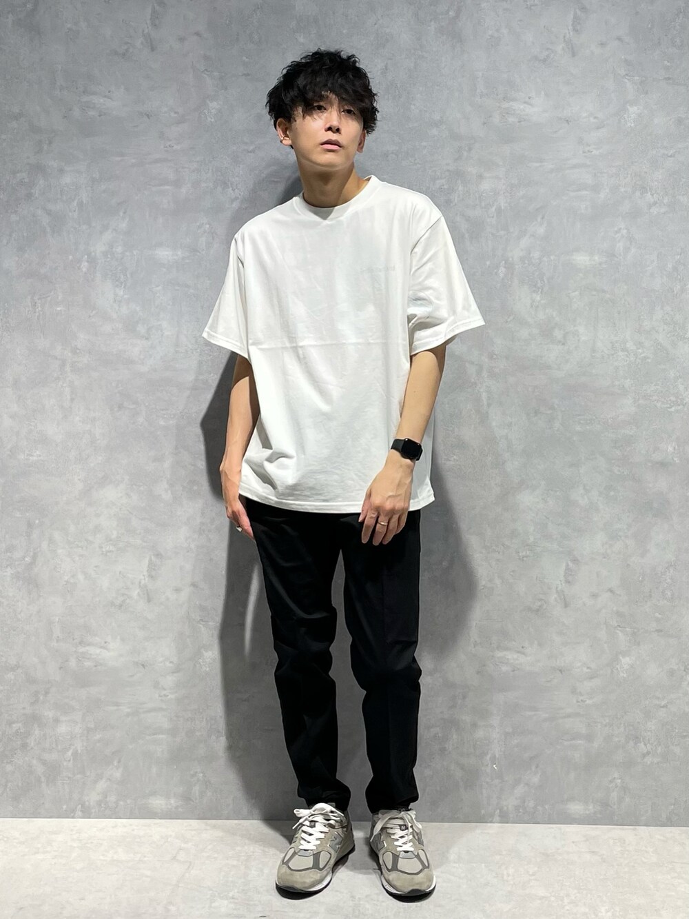 グリーン系のブルゾン、ホワイト系のTシャツ/カットソー、ブラック系のスラックスを着用したメンズの春コーディネートの4枚目の写真