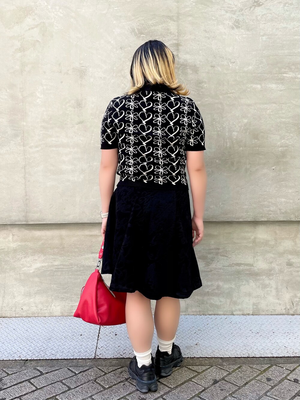 ブラック系のシャツ/ブラウス、ブラック系のスカート、レッド系のハンドバッグを着用したレディースの秋コーディネートの2枚目の写真