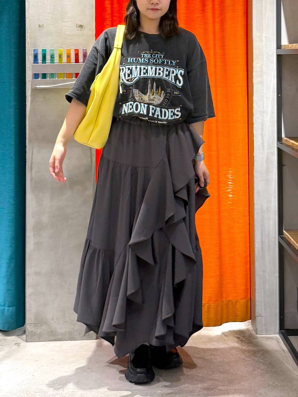 グレー系のスカート、イエロー系のトートバッグ、グレー系のTシャツ/カットソーを着用したレディースの春コーディネートの8枚目の写真