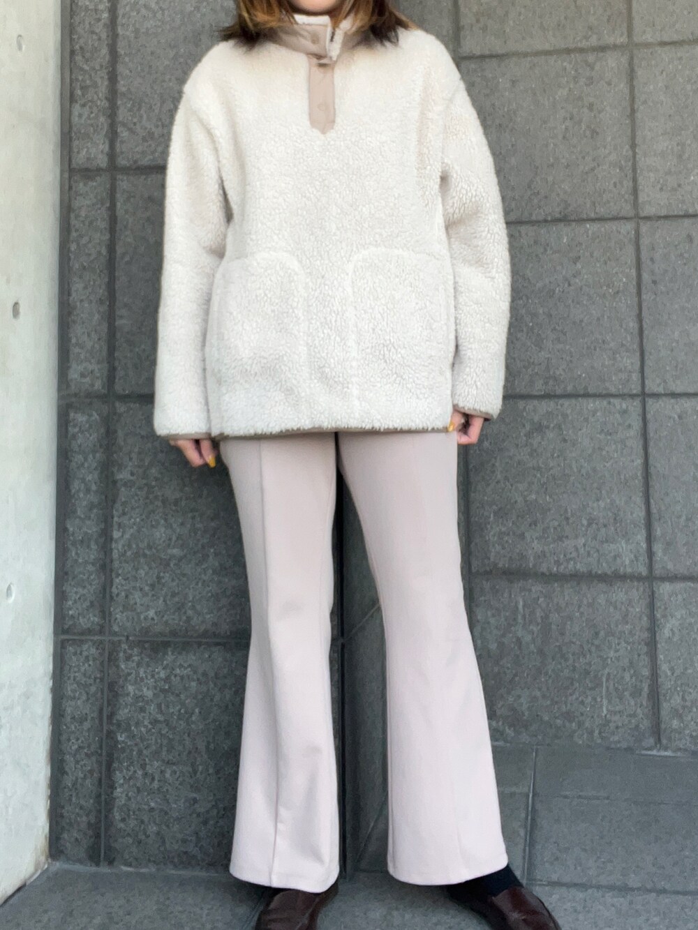 ベージュ系のトップス、グレー系のノーカラーコート、ピンク系のパンツを着用したレディースの春コーディネートの2枚目の写真