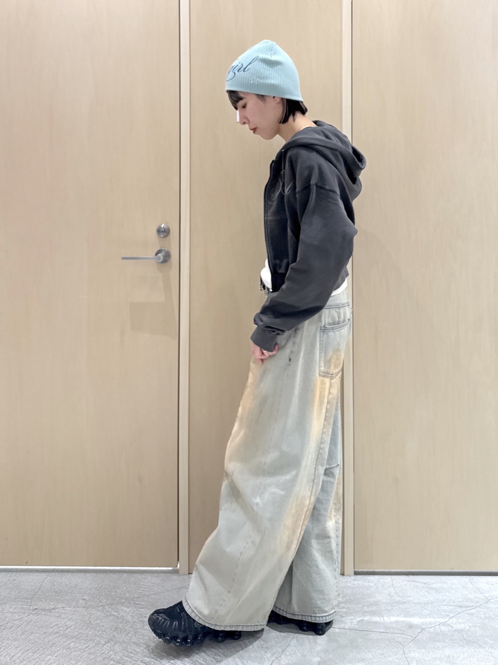 ブルー系のデニムパンツ、ホワイト系のTシャツ/カットソー、ブラック系のパーカーを着用したレディースの春コーディネートの2枚目の写真