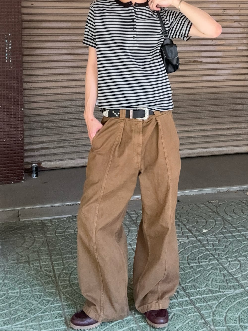 ブラウン系のパンツ、レッド系のモカシン/デッキシューズ、グレー系のTシャツ/カットソーを着用したメンズの夏コーディネートの2枚目の写真