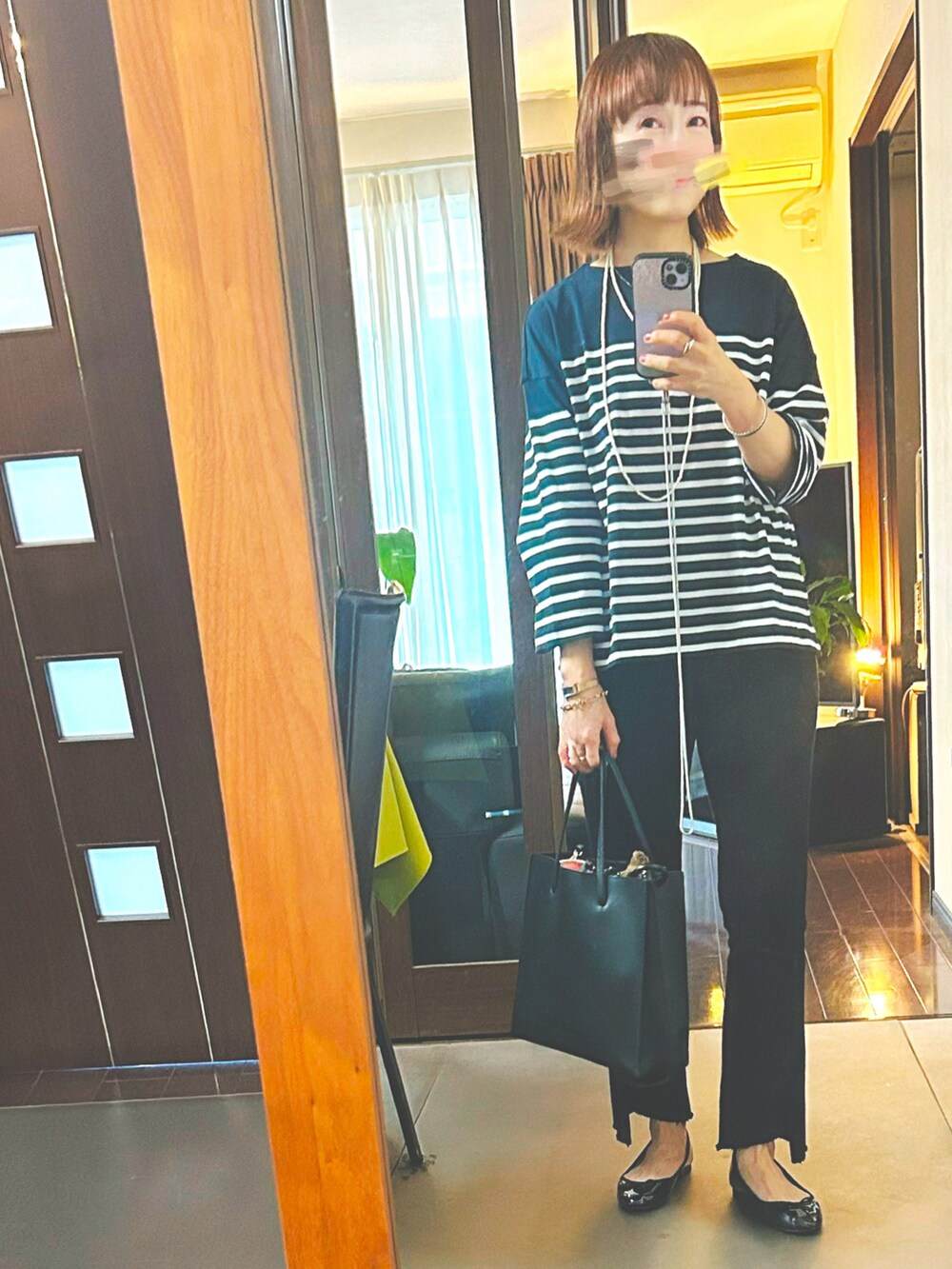 ブルー系のTシャツ/カットソー、ベージュ系のマウンテンパーカー、ブラック系のチノパンツを着用したレディースの秋コーディネートの2枚目の写真