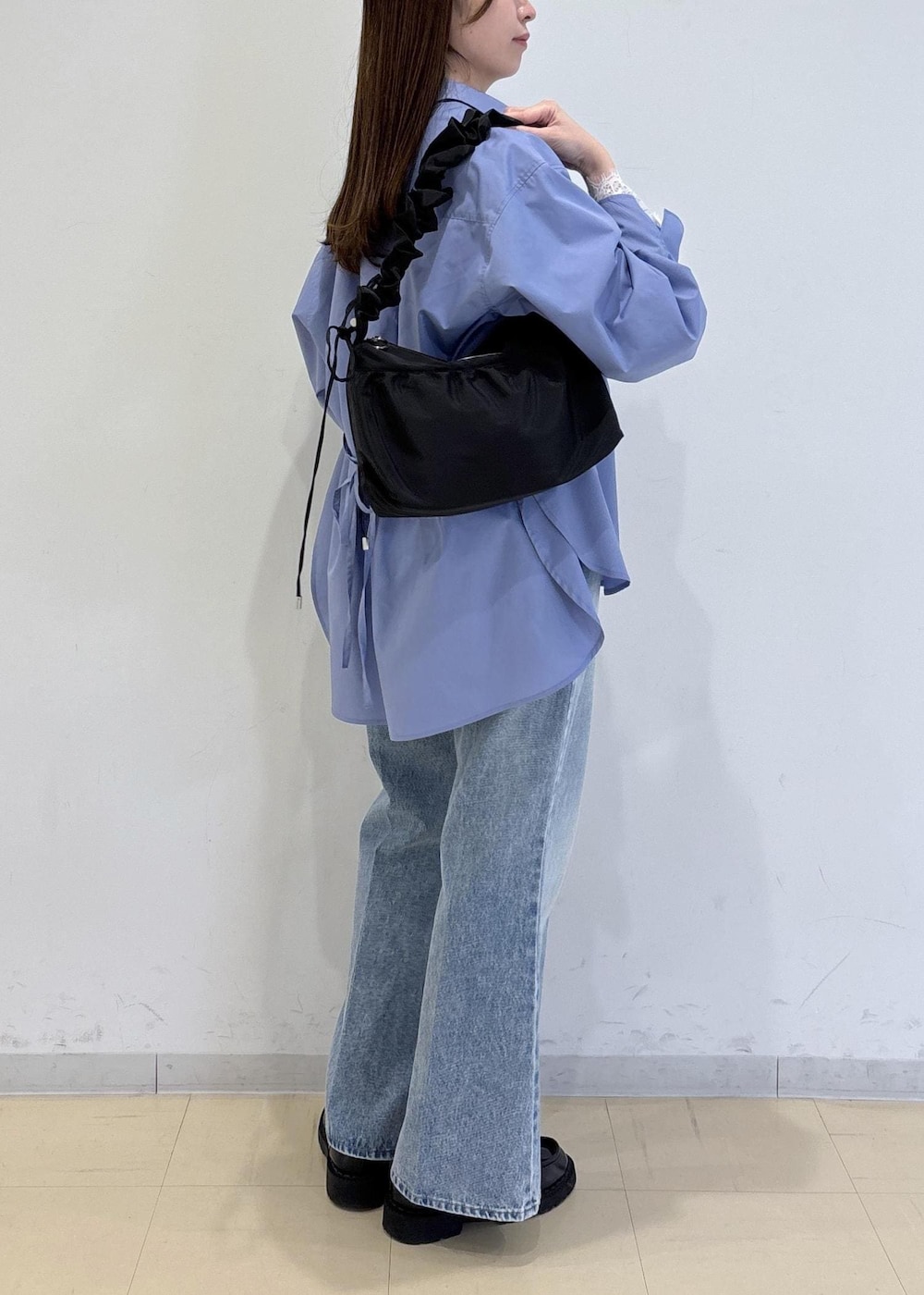 ホワイト系のTシャツ/カットソー、ブルー系のデニムパンツ、ブルー系のシャツ/ブラウスを着用したレディースの冬コーディネートの3枚目の写真