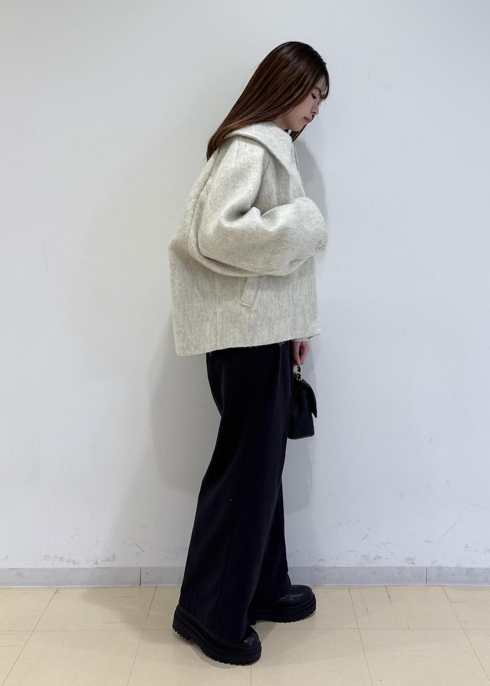 ブラック系のブーツ、ホワイト系のブルゾン、ピンク系のニット/セーターを着用したレディースの冬コーディネートの3枚目の写真