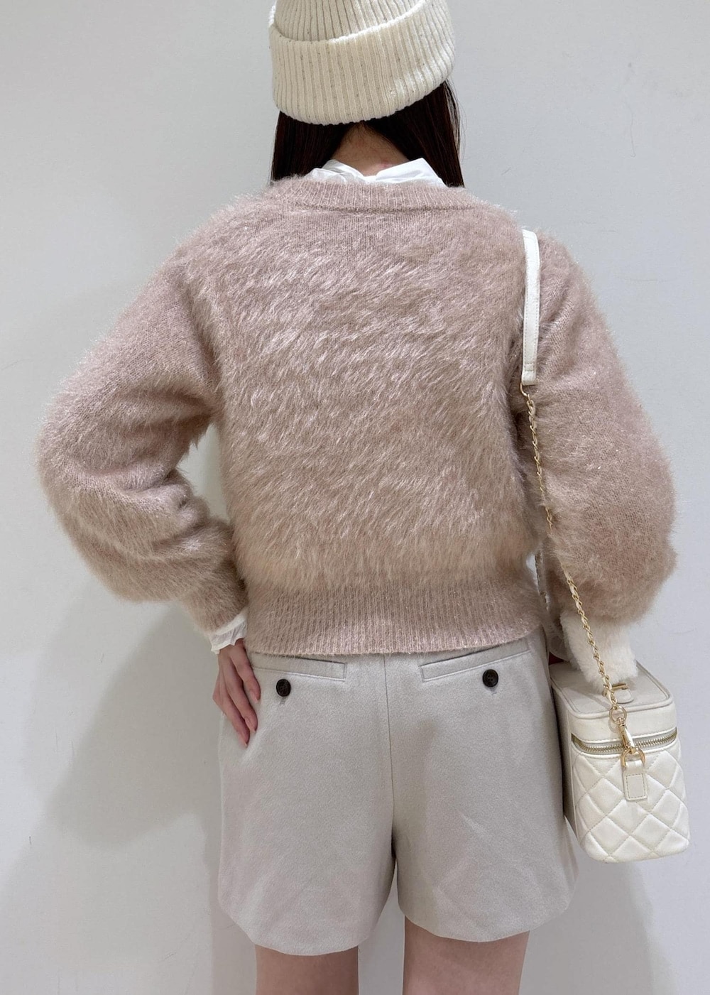 ブラウン系のブーツ、ベージュ系のその他パンツ、ホワイト系のハンドバッグを着用したレディースの冬コーディネートの7枚目の写真