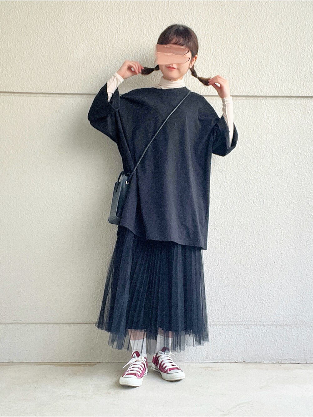 ブラック系のTシャツ/カットソー、ホワイト系のTシャツ/カットソー、ブラック系のスカートを着用したレディースの冬コーディネートの3枚目の写真